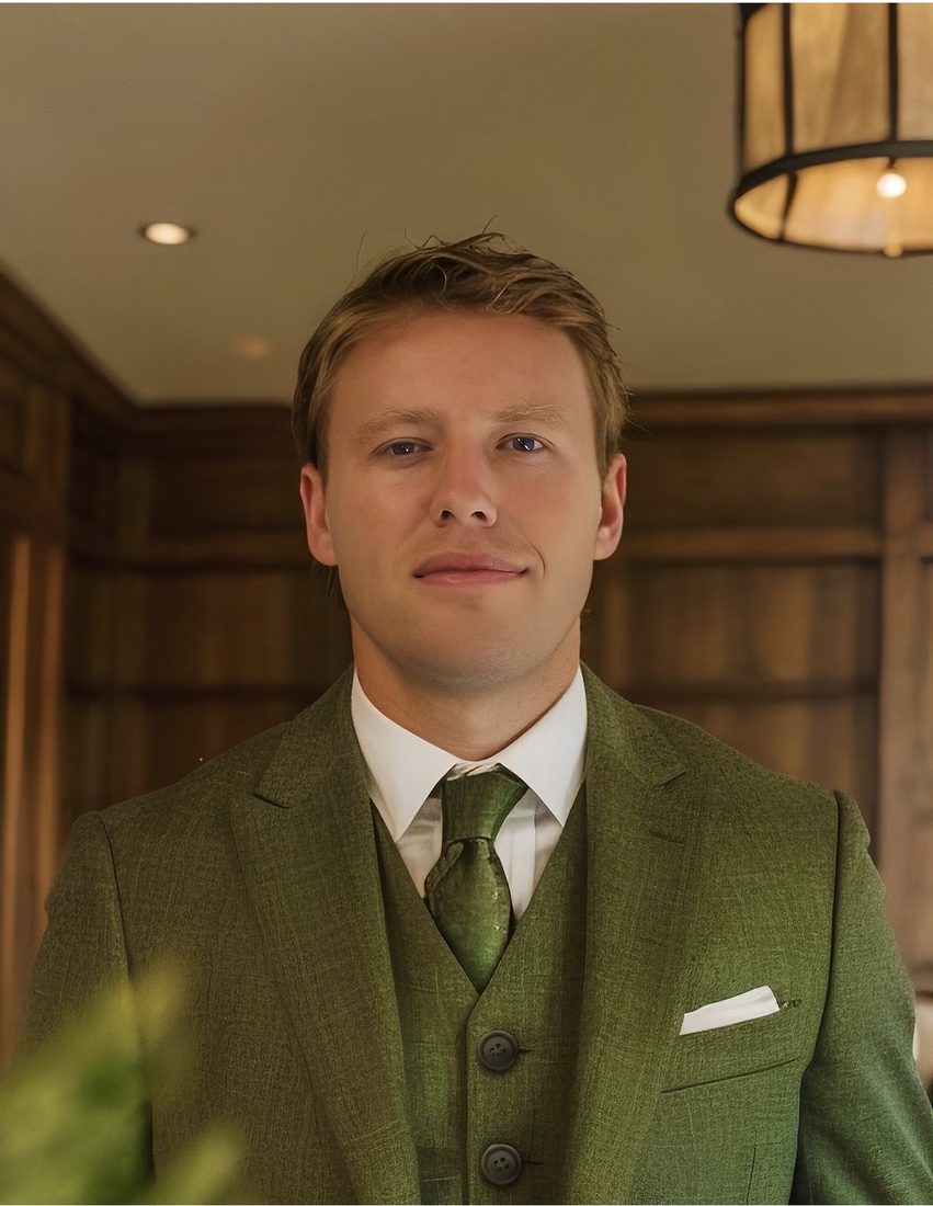 Portrait of Chad Allen in a green three-piece suit