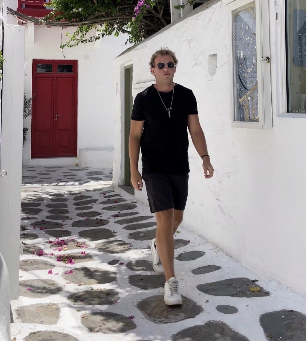 Chad Allen walking down a whitewashed stone street